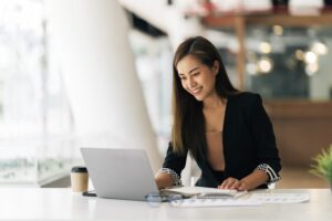 Cheerful,Business,Lady,Working,On,Laptop,In,Office,,Asian,Happy
