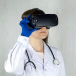 a woman in a white coat and blue gloves is wearing a virtual headset