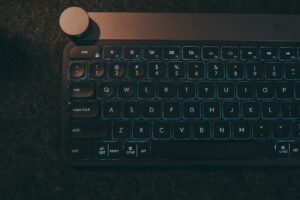 A computer keyboard sitting on top of a table